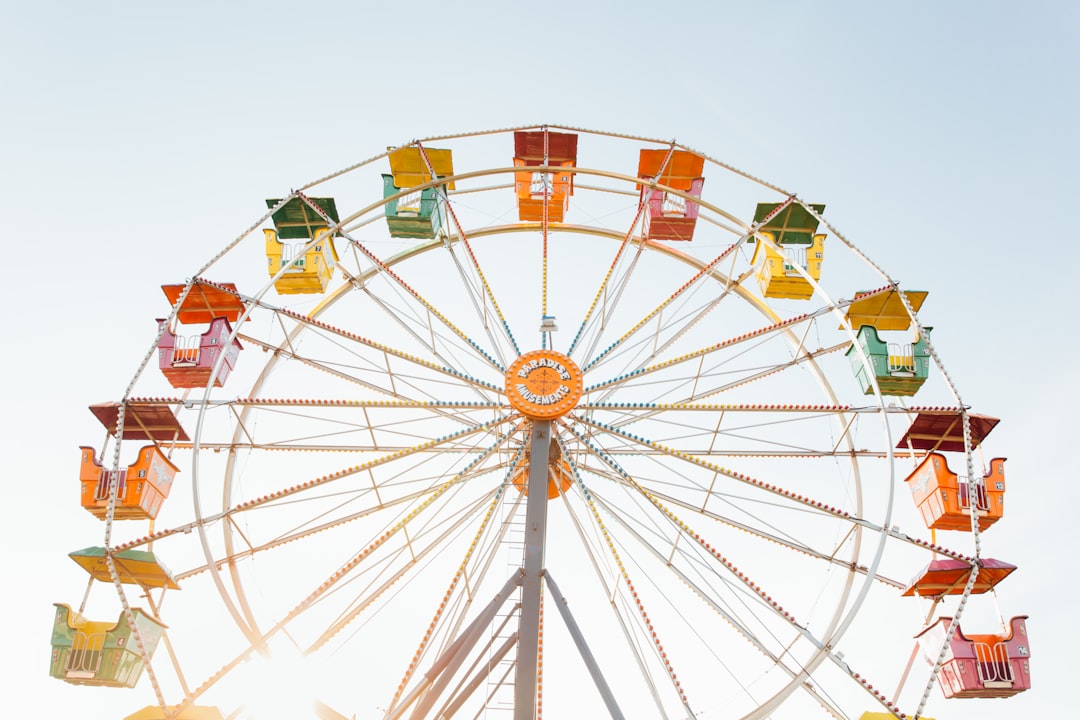 worms eye view of red, orange, and yellow Ferris wheel