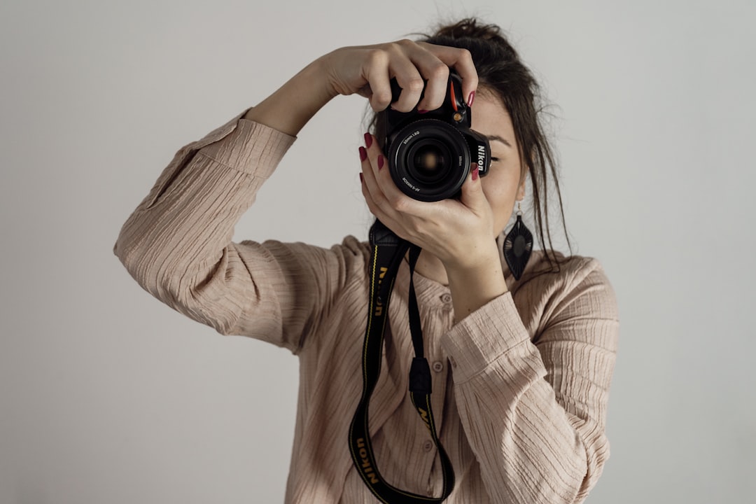 a woman taking a picture with a camera