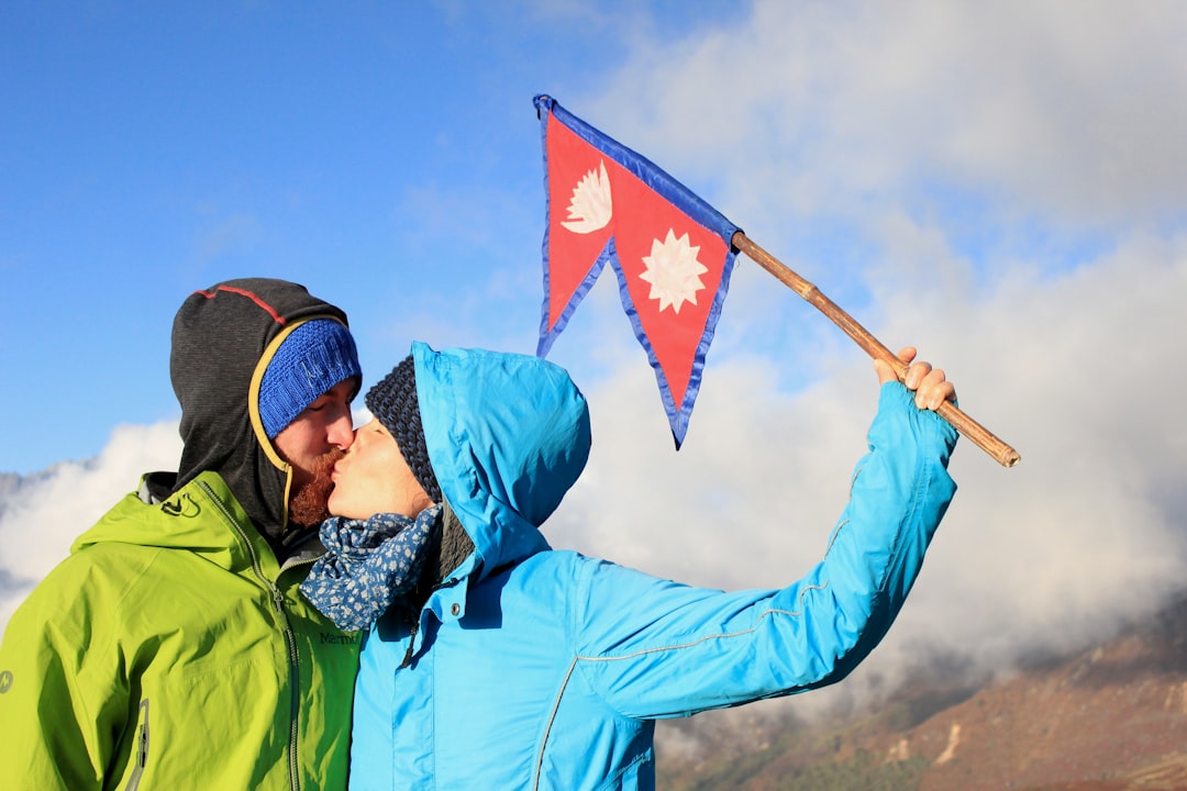 a man and a woman holding a canadian and canadian flag