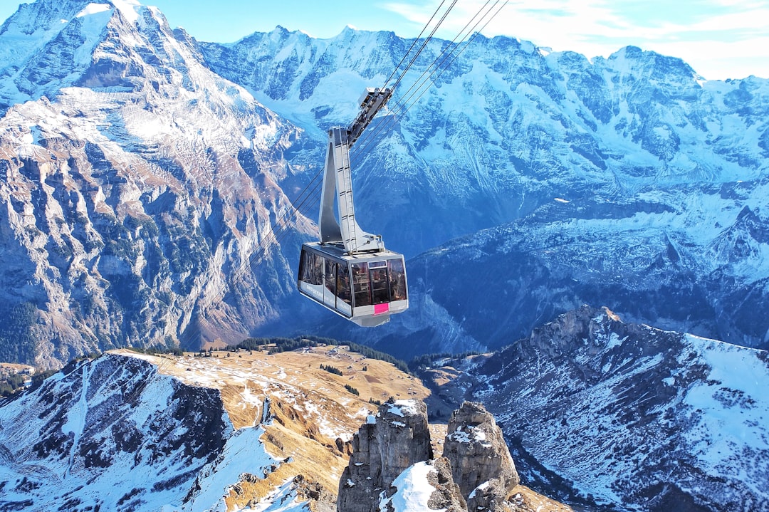 birds eye view of ski lift over mountains during winter